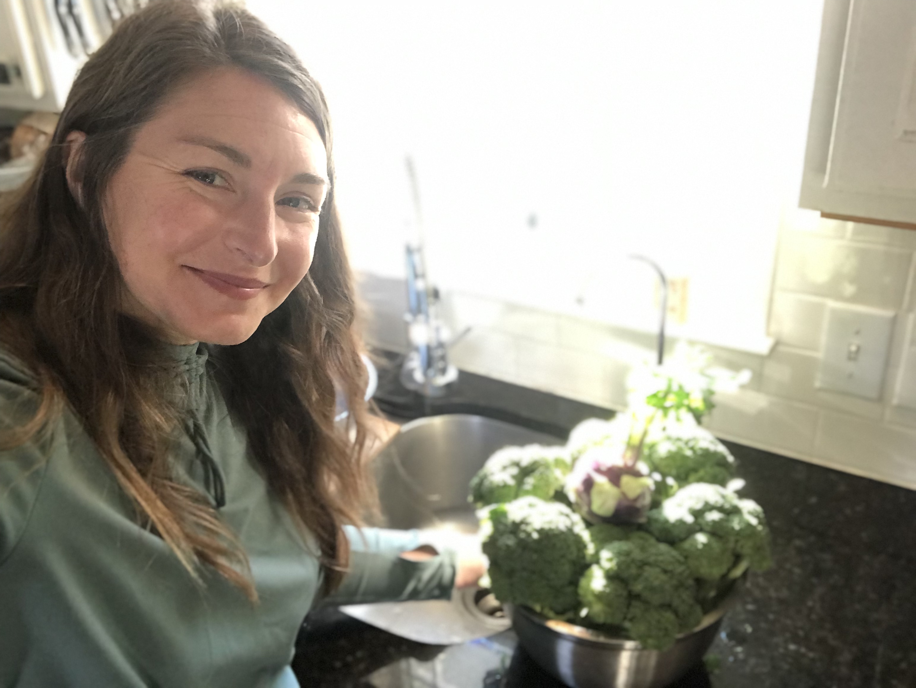 Brie in kitchen with broccoli harvested before frost